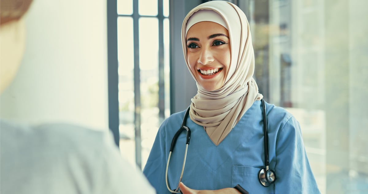 A healthcare professional talks to a patient. 