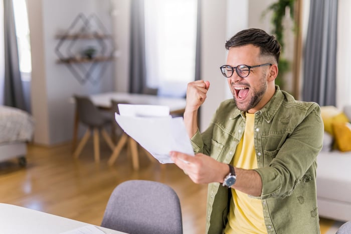 An excited person holding a statement.
