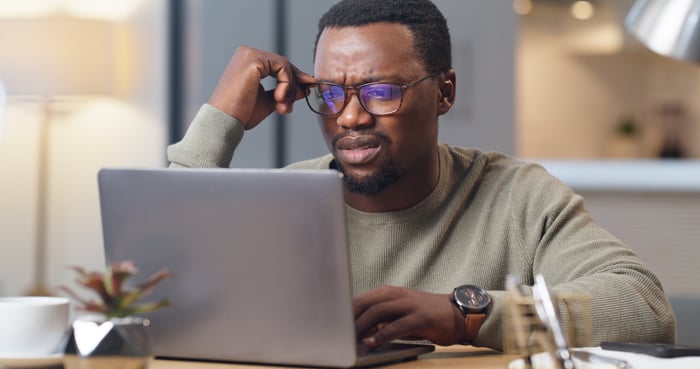 An investor looking at a laptop screen.