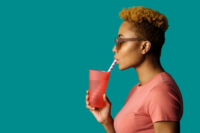 Someone sipping a beverage through a straw.