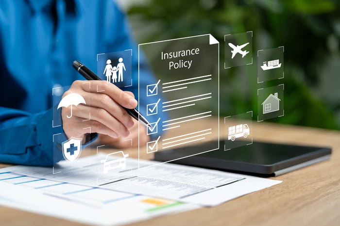 A hand with a pen points toward a graphic that says Insurance Policy.