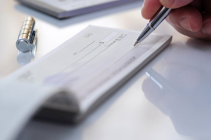 A pen hovers over a black check.