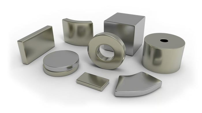 Several silvery objects of different shapes lined up next to each other. 