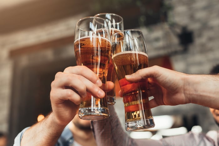 Friends clinking beer glasses.