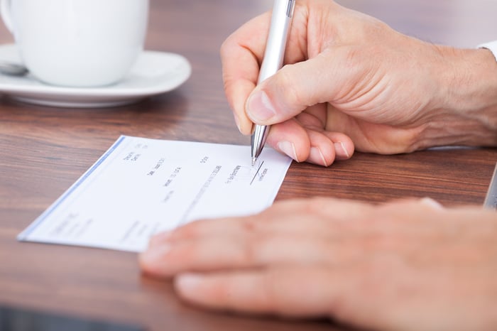 A person filling in a blank check.