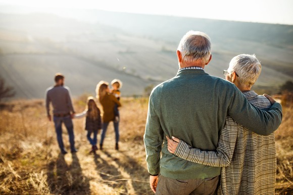 Grandparents looking at their children and grandchildren.