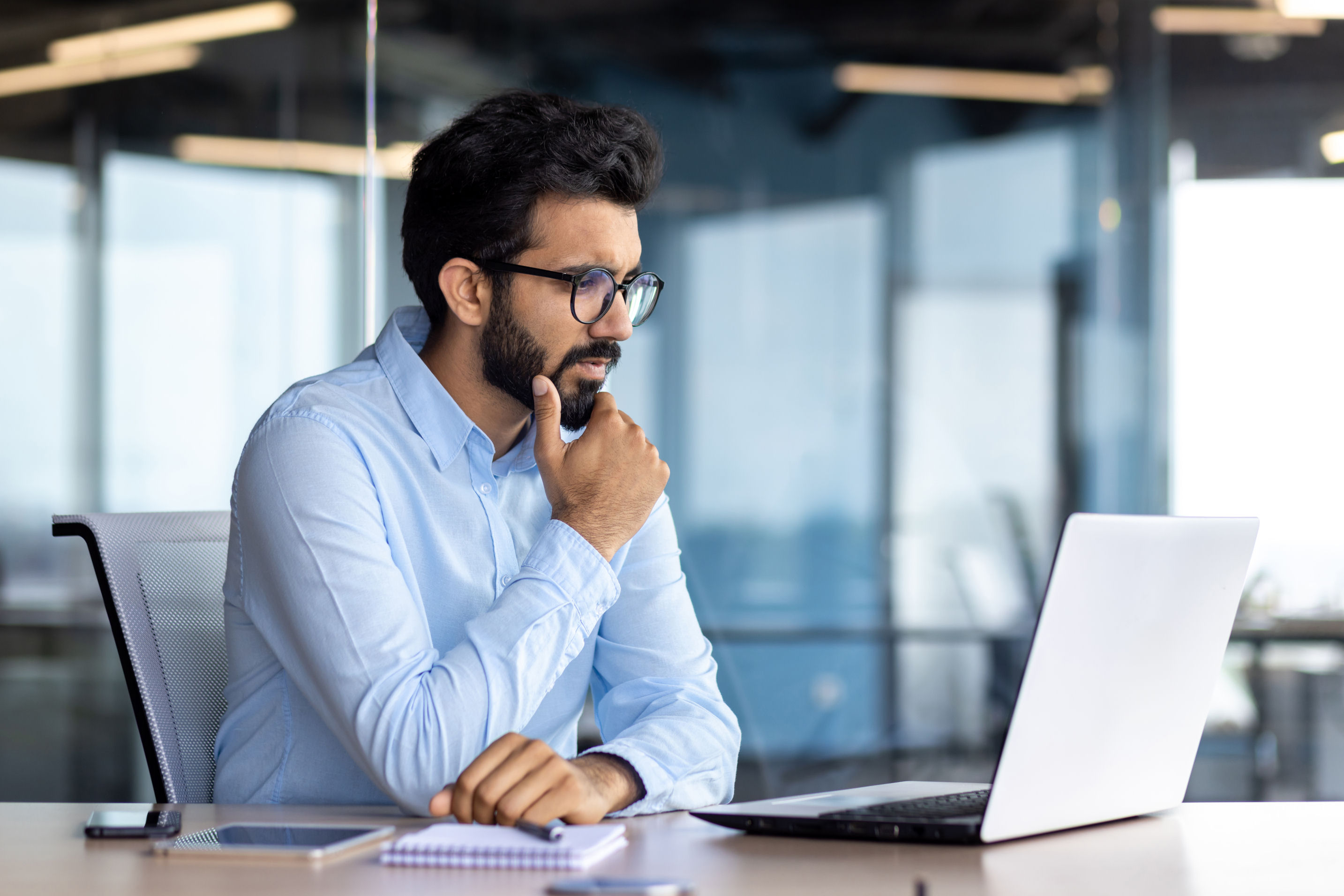 thinking investor using a laptop computer