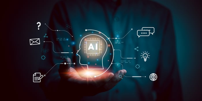 Digital images and "AI" displayed over a person's outstretched palm.