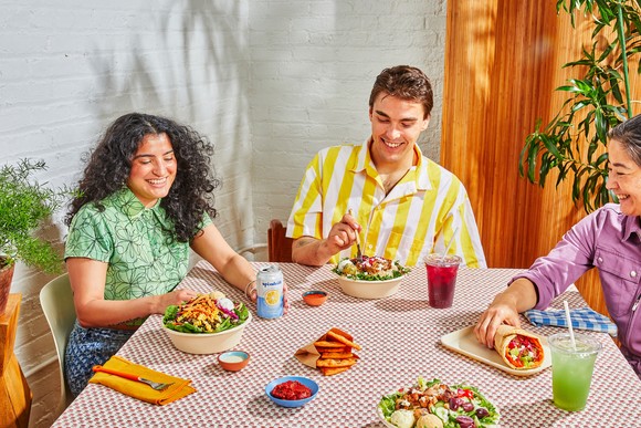 A group of people eating Cava food.