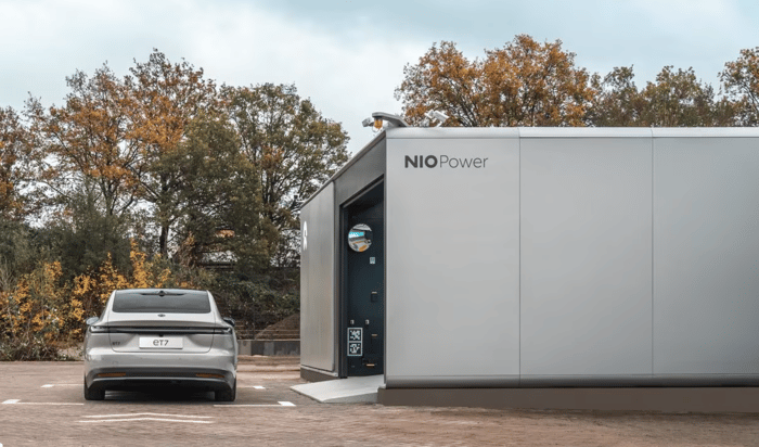 Nio electric ET7 sedan outside a Nio battery swap station. 