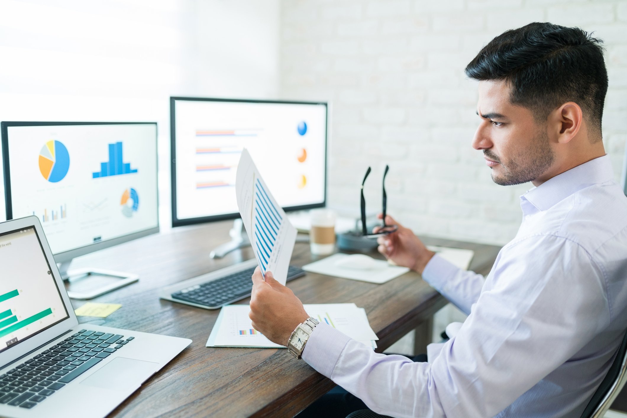 Analyst reviewing charts in an office