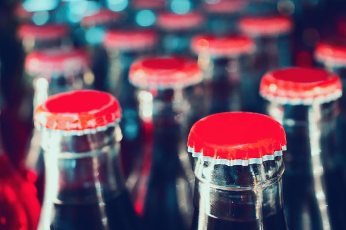 Soda bottles with red caps.