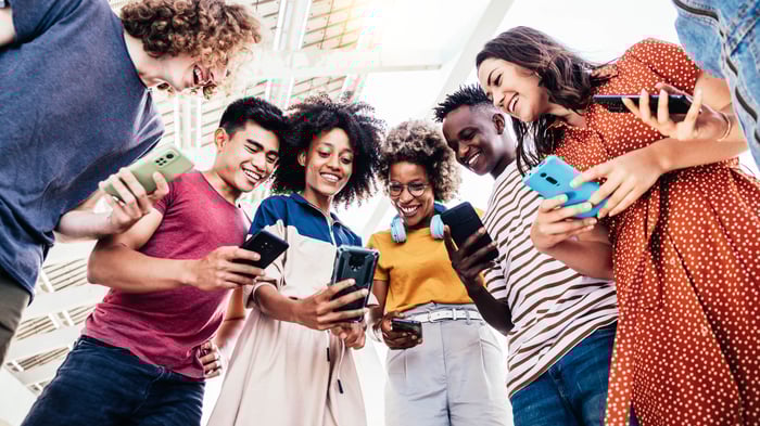 Young people sharing content on their phones.