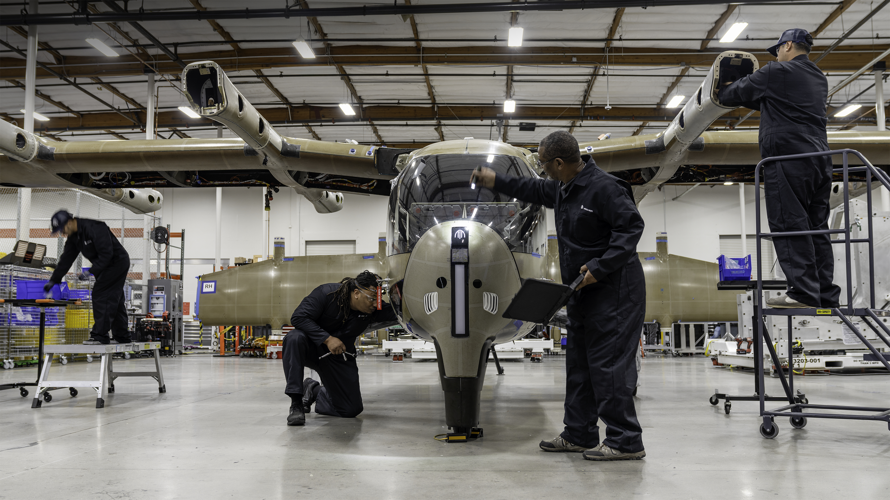 Technicians working on an Archer Aviation Midnight aircraft.