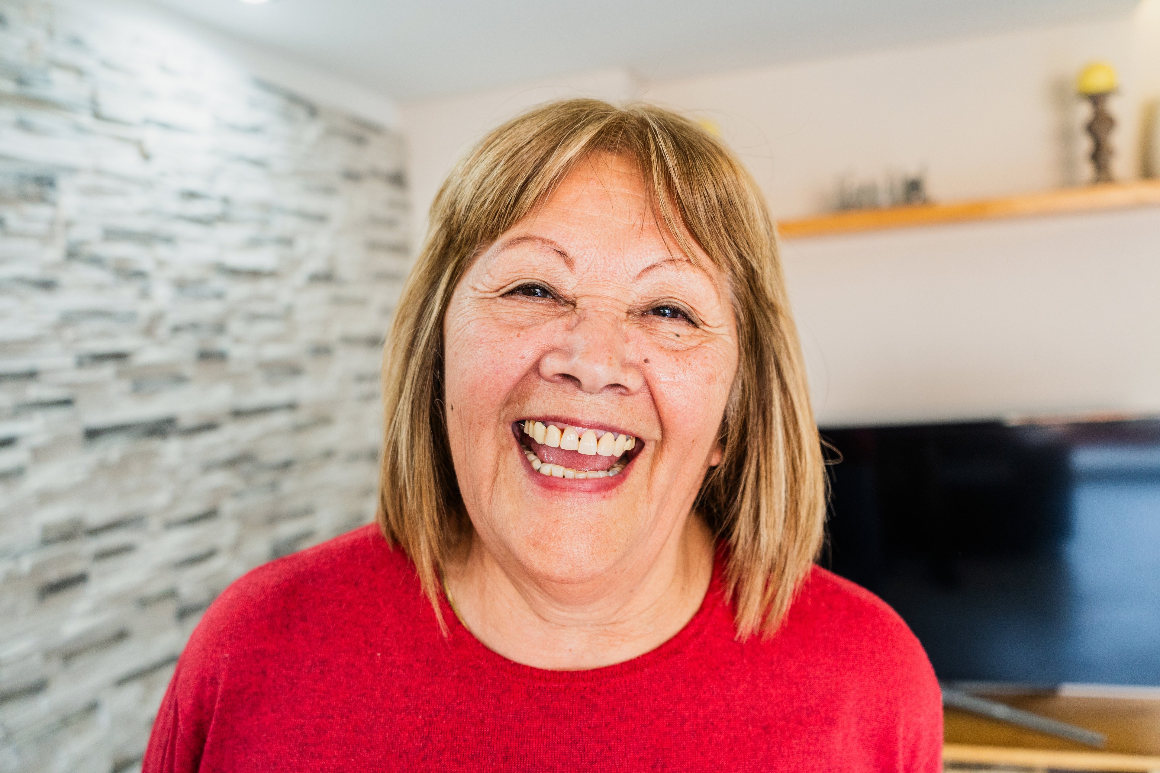 Person in red smiling broadly.