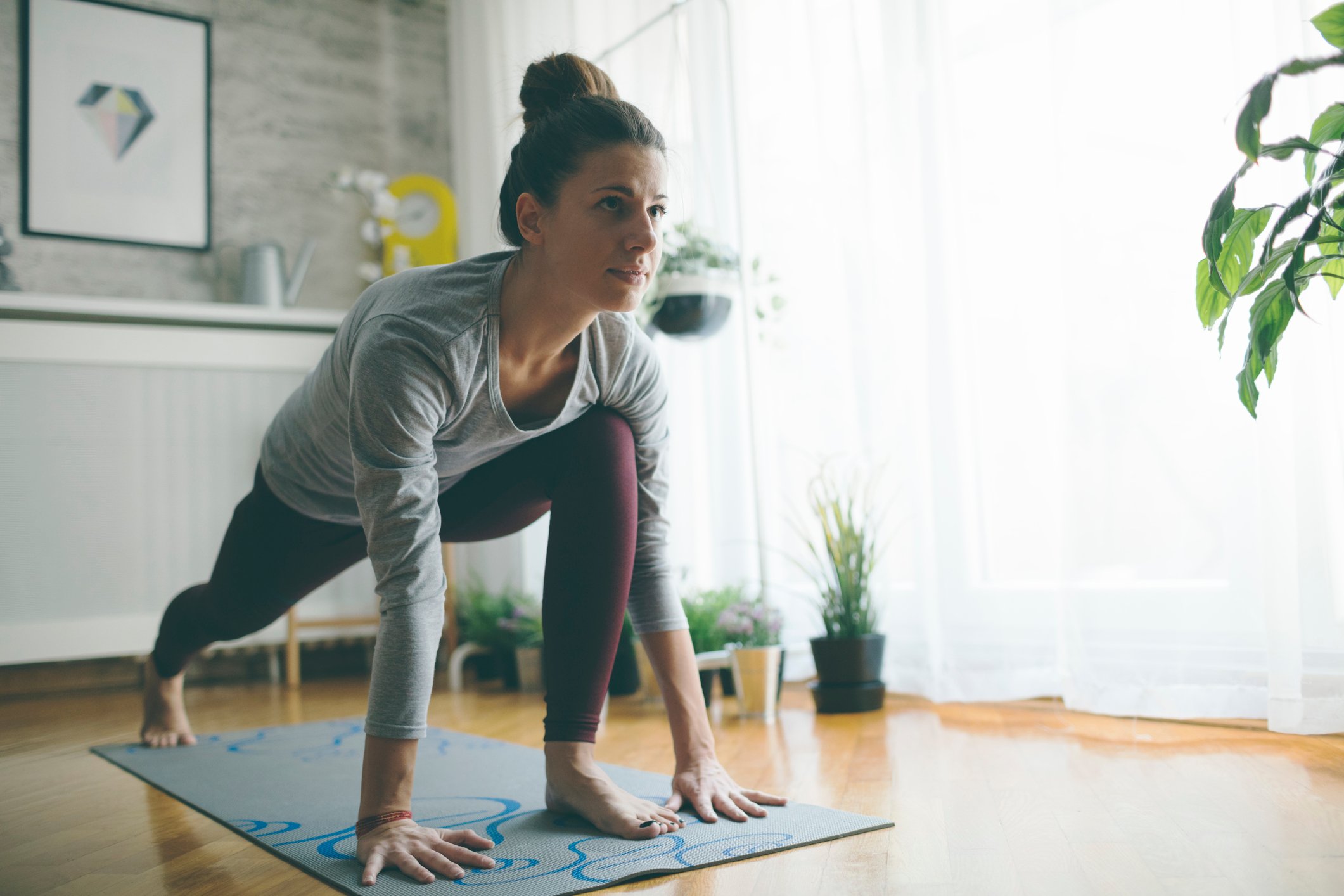 A person doing yoga at home on a mat.