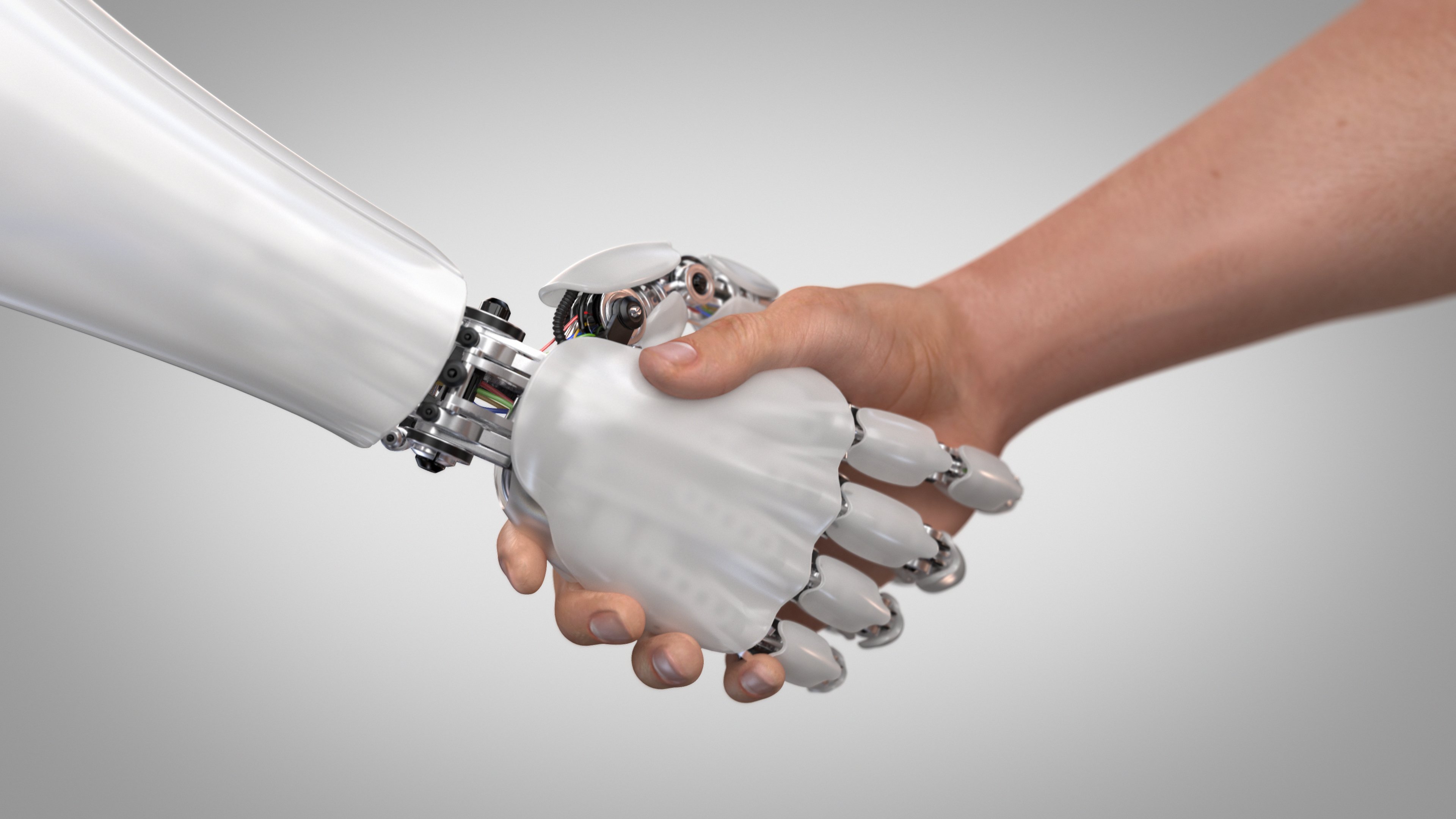 A human shaking hands with a robot.