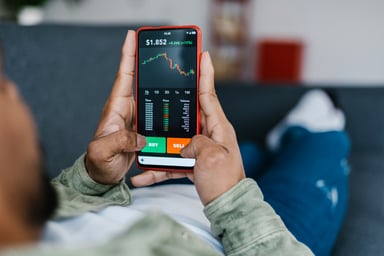 person looks at stock chart on phone getty