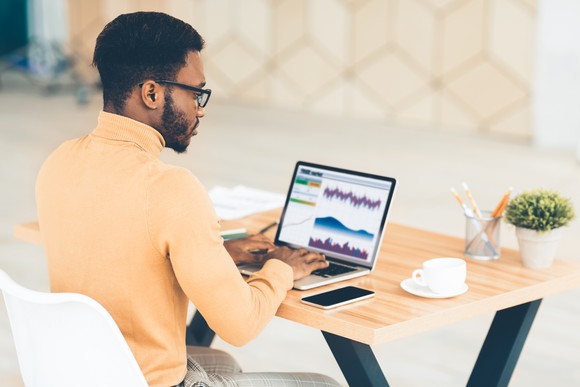 An investor looks at  a stock chart on a laptop.