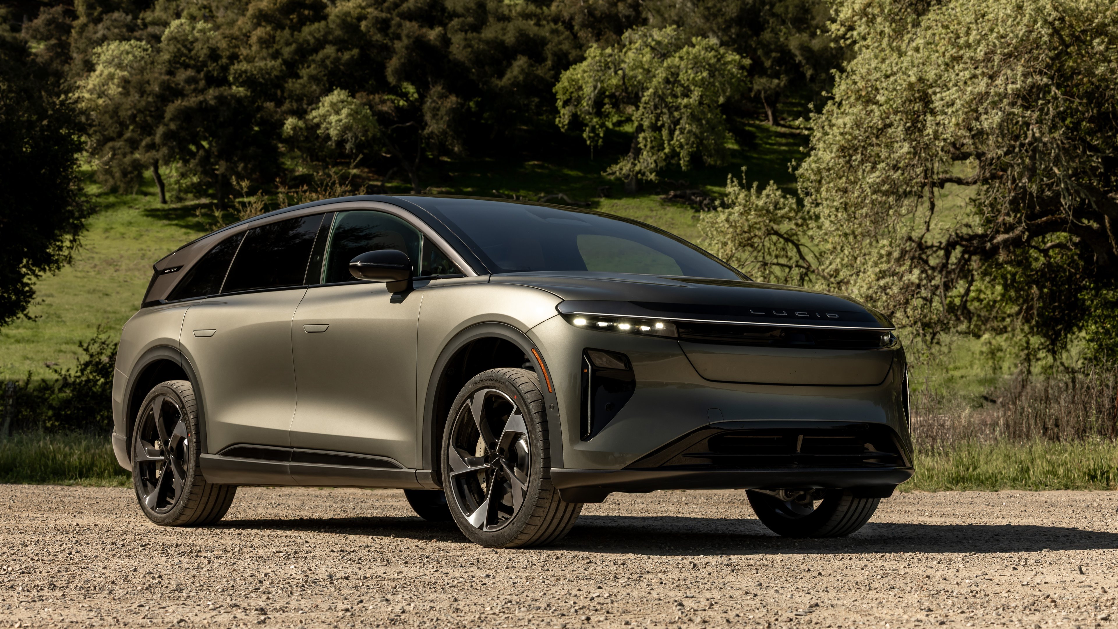 The 2025 Lucid Gravity SUV is shown parked on a gravel road.