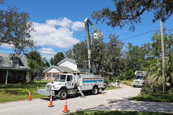 A Florida Power & Light line crew bucket truck does repairs after a storm.