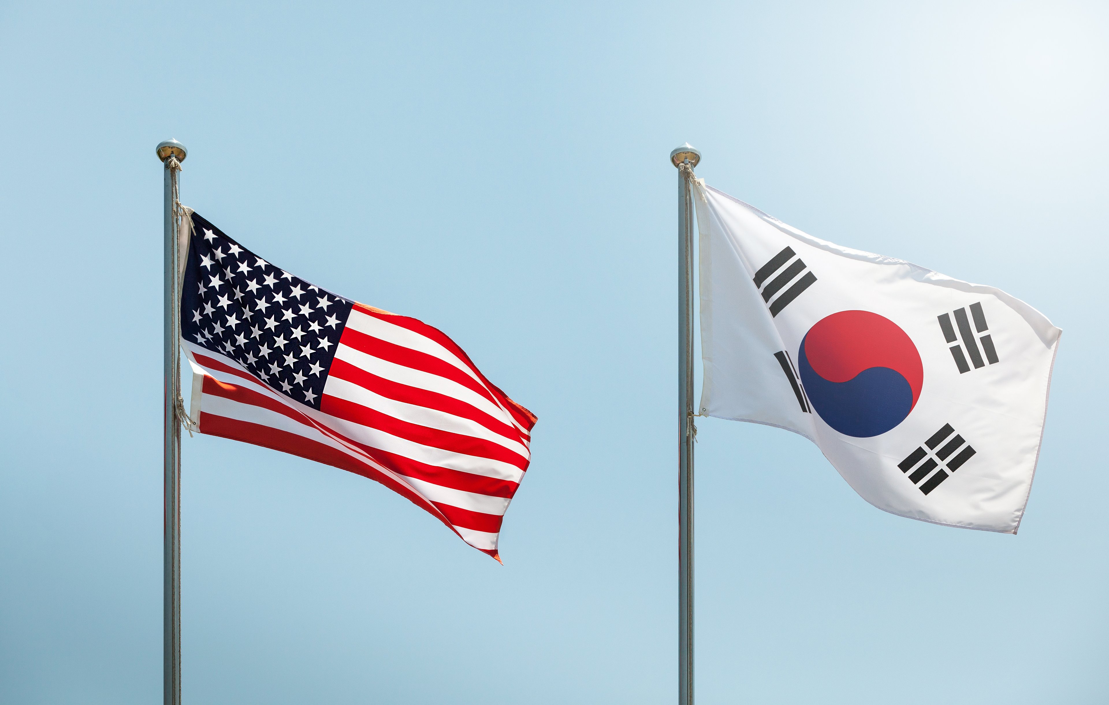 American and South Korean flags fly side by side.