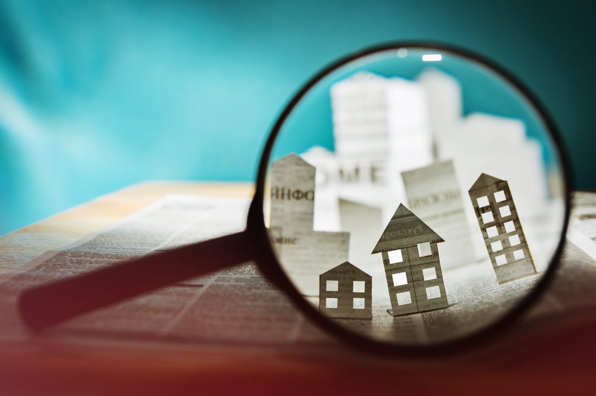 A magnifying glass looking at buildings. 
