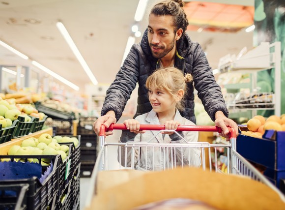 Parent and child shopping for produce. 