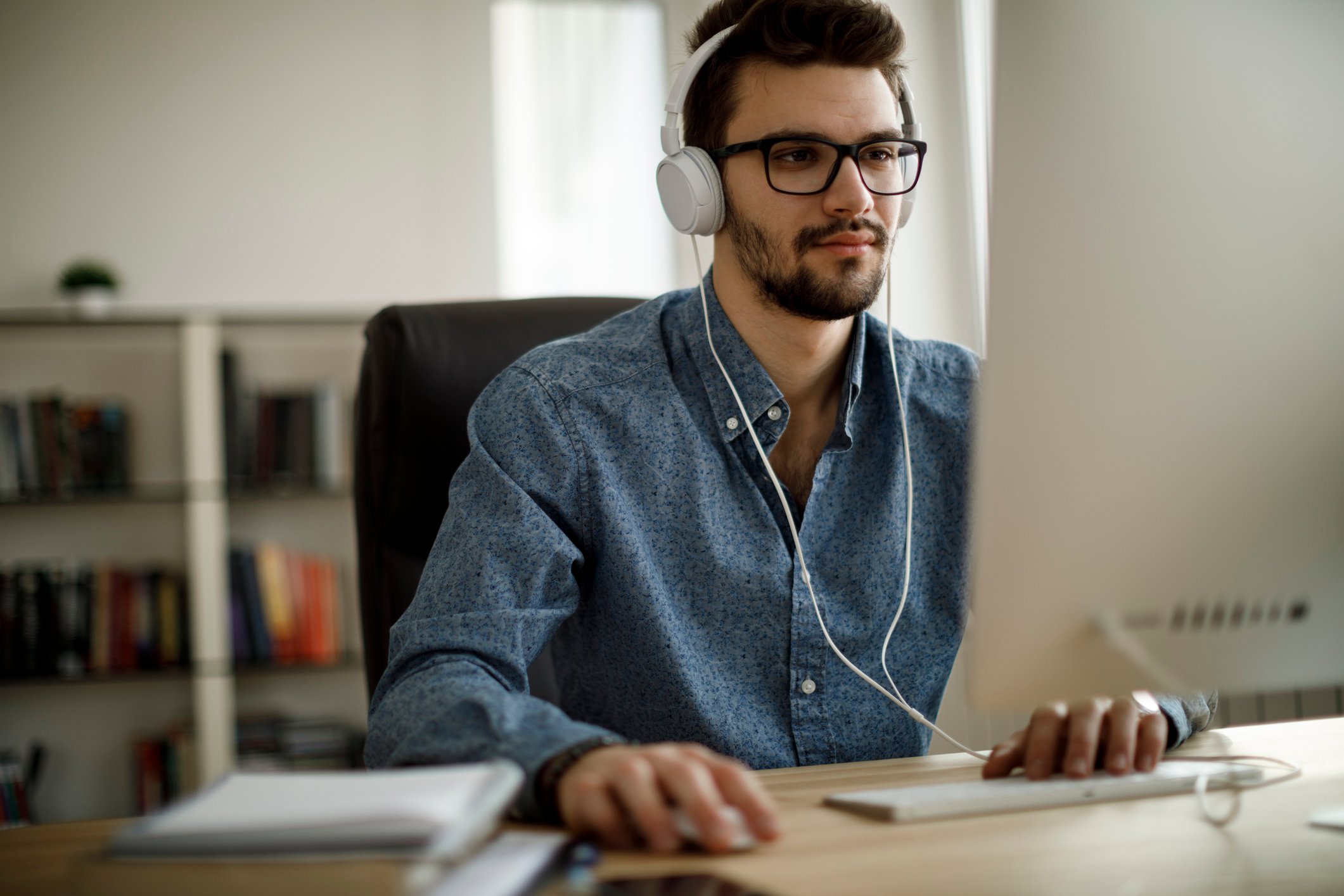Person with headphones on using computer.