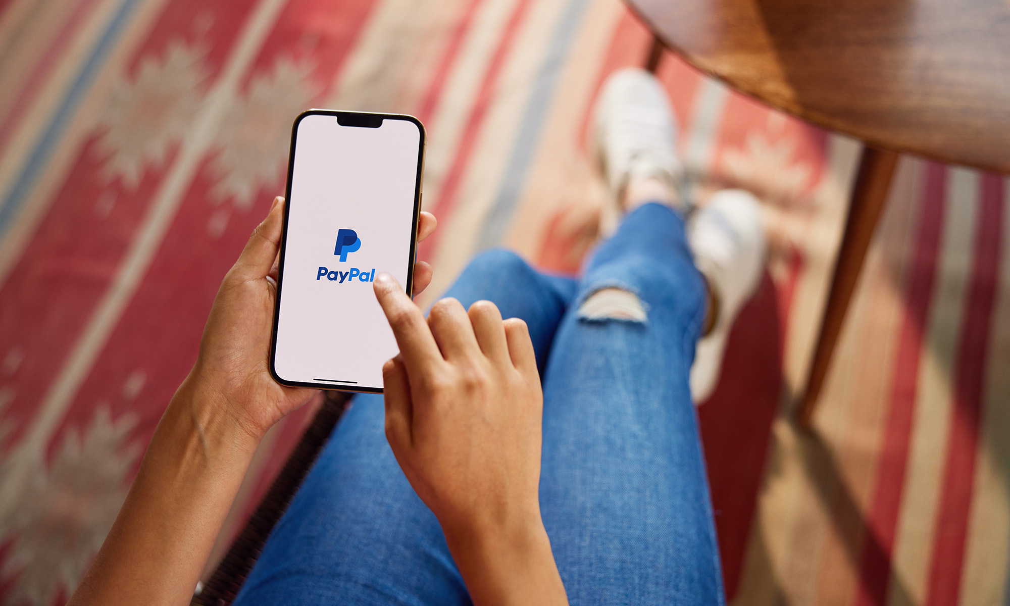 Person holding phone with PayPal app 3_PayPal