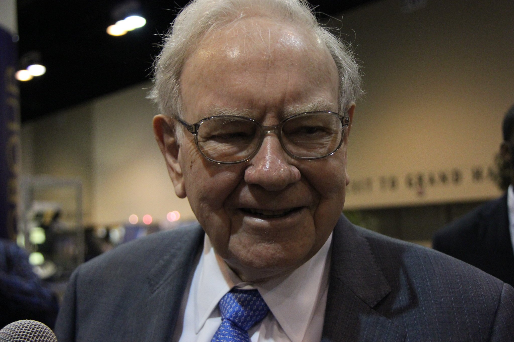 Warren Buffett headshot looking to the right of the camera and slightly smiling. 