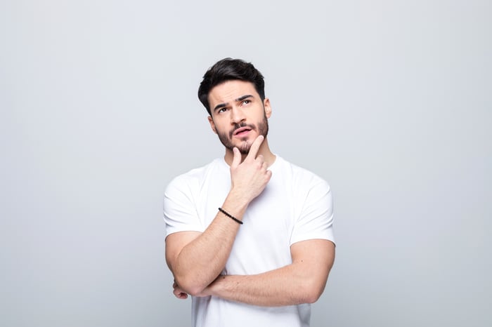 Person in a thinking pose and looking perplexed.