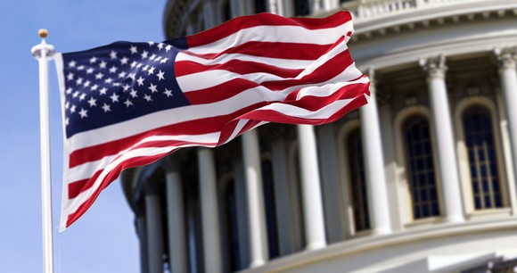 American flag in front of the Capitol.