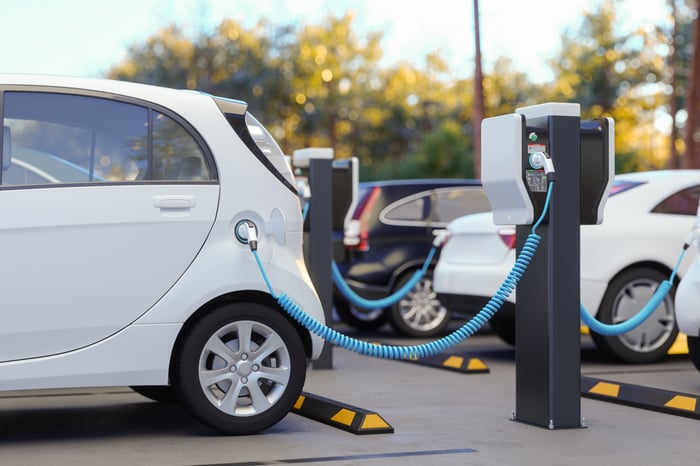 An electric vehicle battery charging at a charging station.