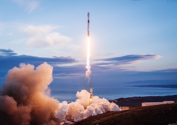 A rocket taking off from a launchpad. 