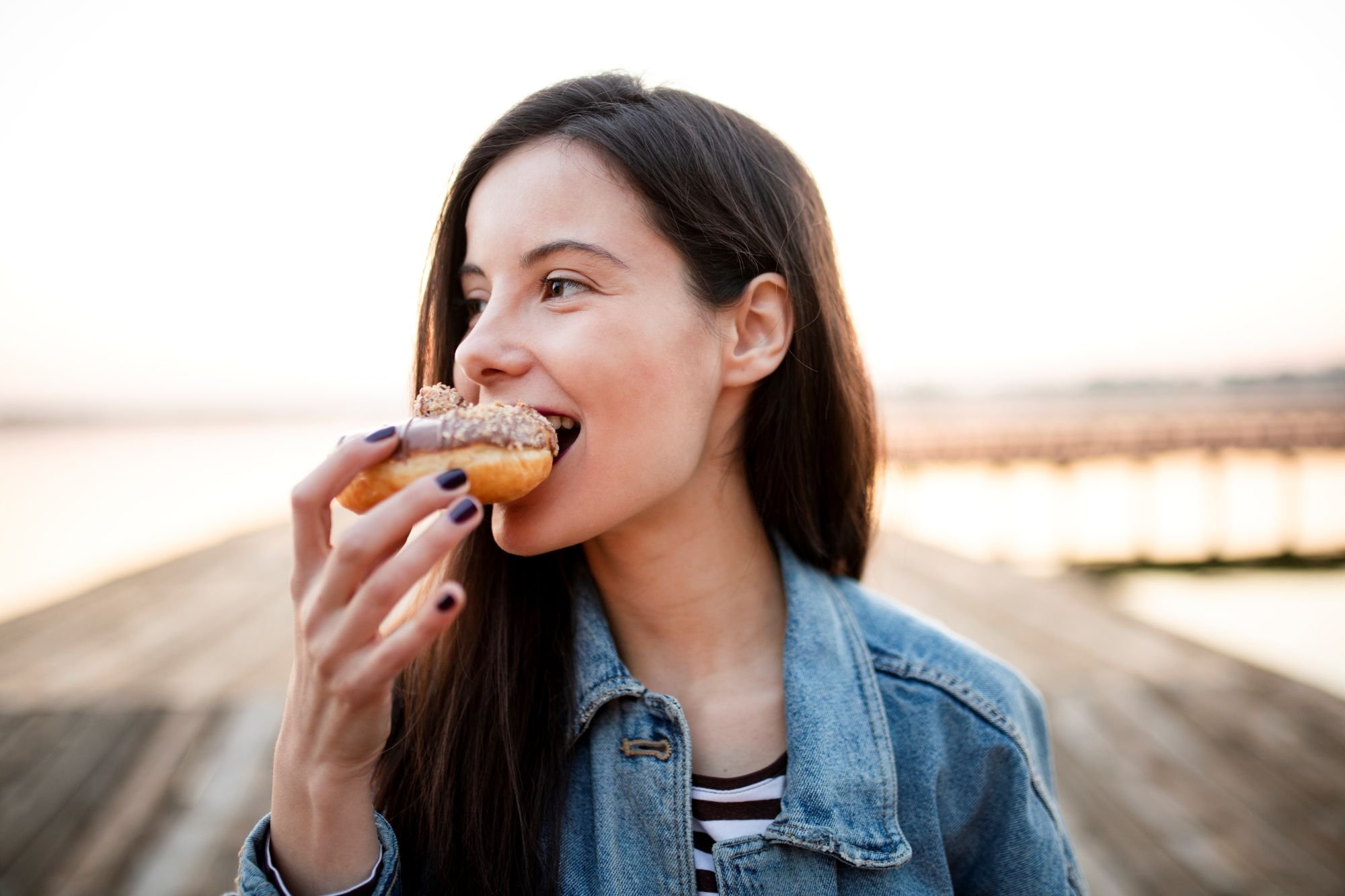 A person eating a donut