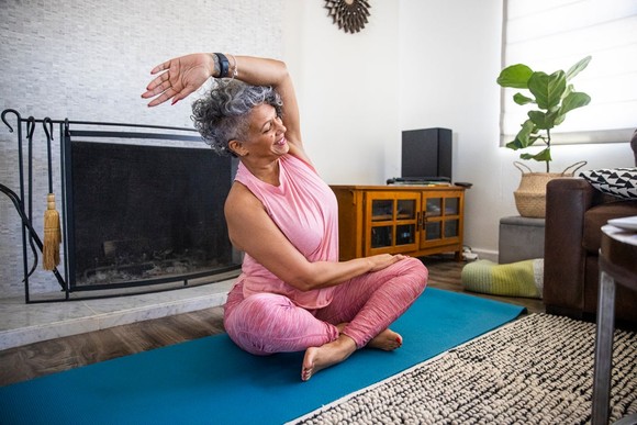 Person doing yoga in living room.