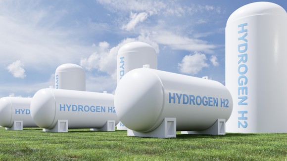 Large hydrogen energy storage tanks in a field.