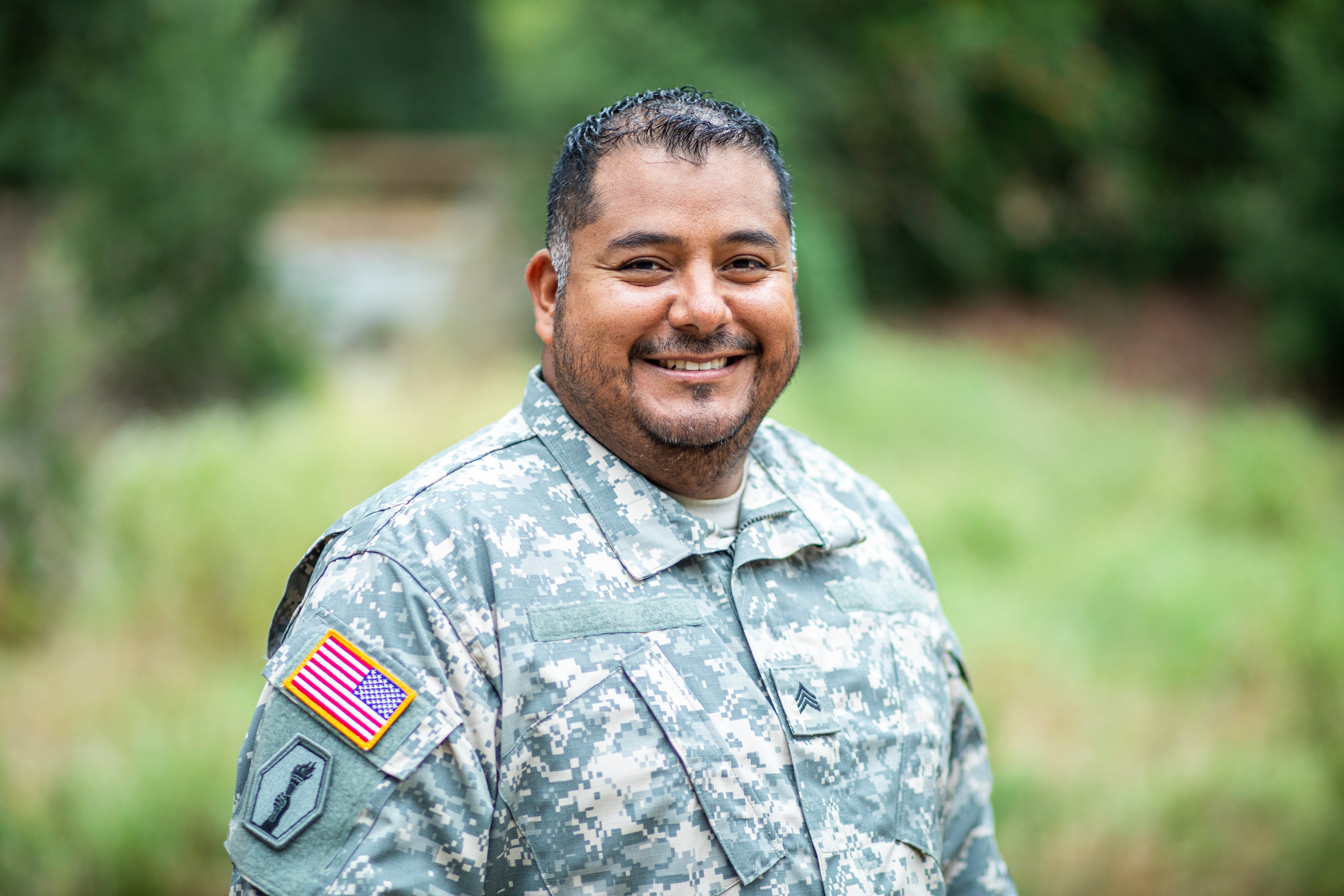 Person in a military uniform smiling.
