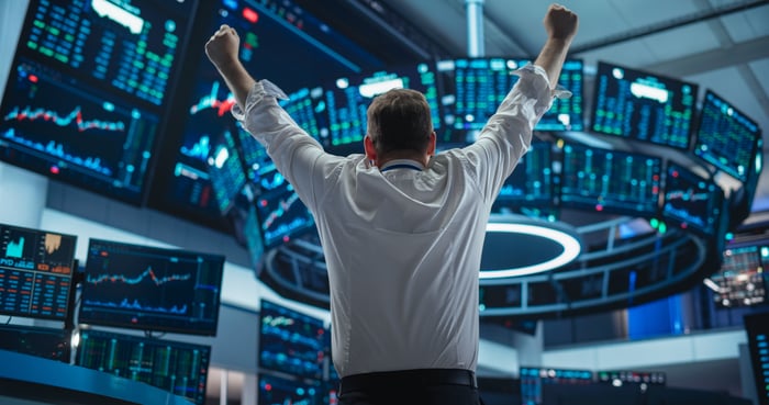 A trader on the exchange floor cheering.