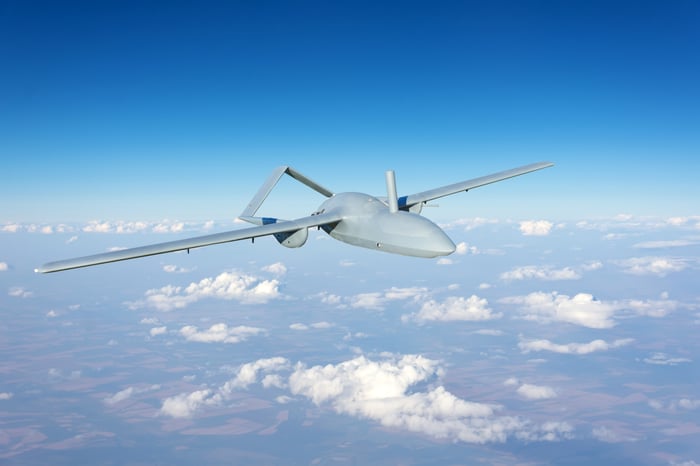 An unmanned military drone flying in the sky.