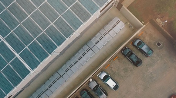 Aerial view of fuel cell and solar panel installation next to a parking lot. 