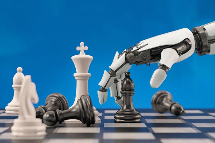 A robotic hand makes a move on a chess board.