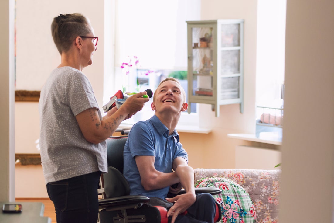 Person in a wheelchair, speaking with standing person. 