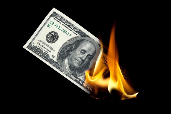 Hundred dollar bill burning.