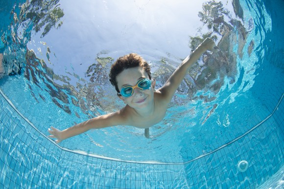 Child underwater in a swimming pool.