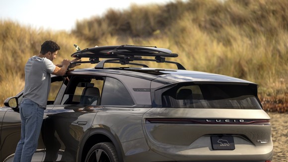 A person standing next to an SUV.