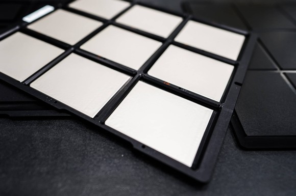 Close up of QuantumScape's solid-state battery technology. Cells are arranged in a black casing. 