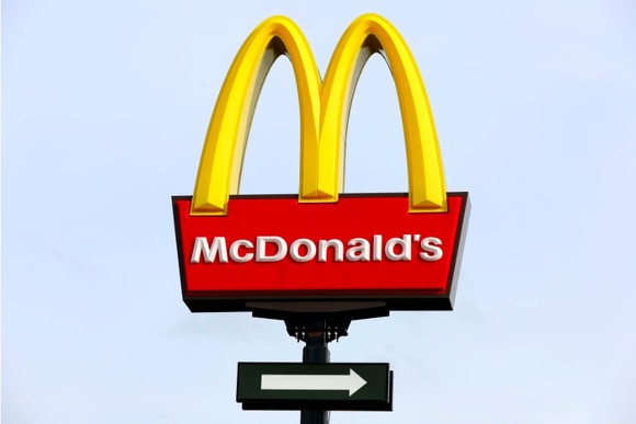 The iconic Golden Arches of McDonald's shown against a blue sky.
