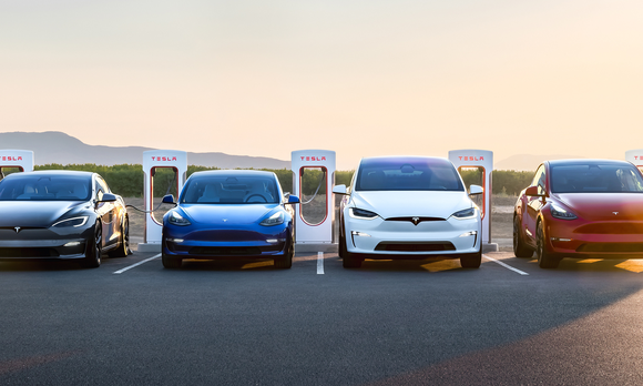 Tesla cars plugged in and charging at sunrise. 
